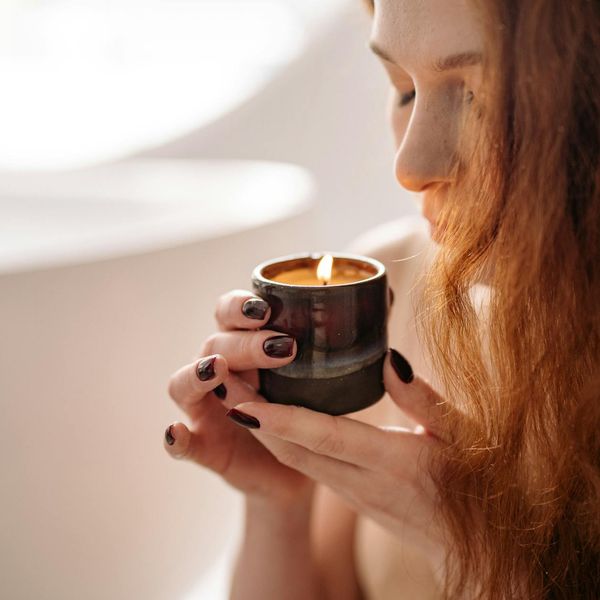 Person meditating peacefully with a subtle light aura around them.